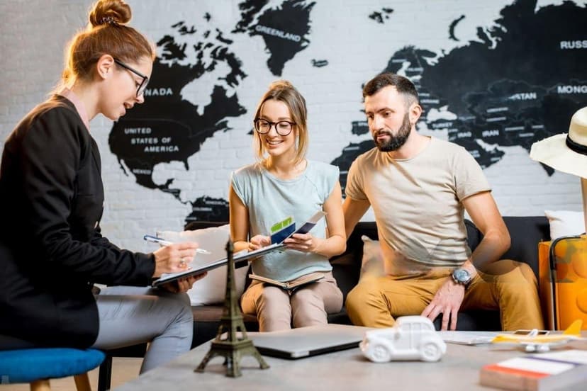 A travel agent with two people discussing about there travel plan