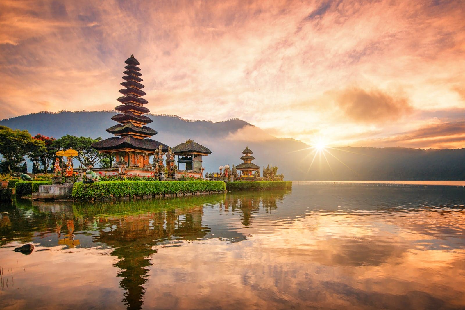 Bali's diverse landscapes include volcanic mountains, scenic beaches, and vibrant coral reefs, making it a popular destination for surfing, relaxation, and cultural experiences. Visitors flock to areas like Kuta for nightlife, Ubud for art and nature, and Seminyak for luxury.